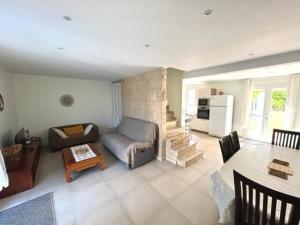 a living room with a couch and a table at Maison climatisée 5 pièces avec jardin privé et parking, proche gare et centre à Argelès-sur-Mer - FR-1-388-217 in Argelès-sur-Mer