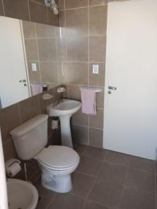 a bathroom with a toilet and a sink at Departamento temporario Puerto Madryn in Puerto Madryn