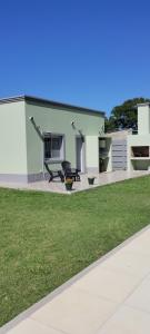 a house with a bench in front of a yard at Los alamos in San Miguel del Monte