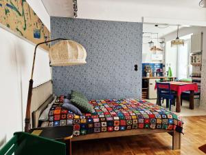 sypialnia z łóżkiem z kolorową kołdrą w obiekcie STUDIO KLIMAT PRAGA w Warszawie