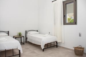 A bed or beds in a room at Christina Apartment