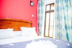 Rúm í herbergi á ALICIA HÔTEL