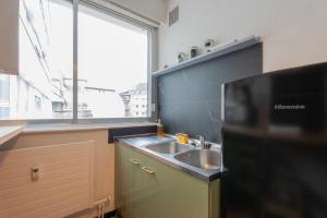 a small kitchen with a sink and a window at MUL HOUSE in Mulhouse