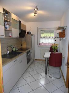 a kitchen with a sink and a table at Ferienwohnung Hof 22 in Hilchenbach
