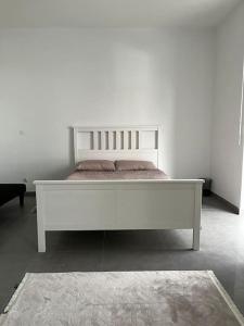 ein großes weißes Bett in einem weißen Zimmer in der Unterkunft Appartement des 3 frontières II in Saint-Louis