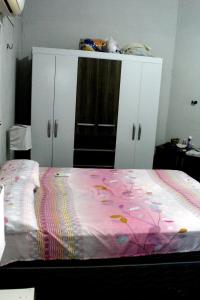 um quarto com uma cama com um cobertor rosa em Casa c WiFi a beira mar na Praia Redonda,Icapui CE em Icapuí