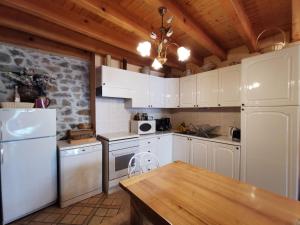 a kitchen with white appliances and a wooden ceiling at Gîte Lorlanges, 3 pièces, 8 personnes - FR-1-582-352 in Lorlanges
