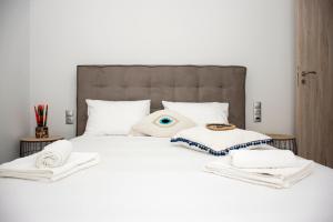 A bed or beds in a room at Christina Apartment
