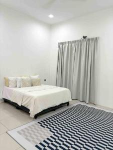 a white bedroom with a bed and a curtain at Homestay taiping in Taiping