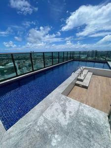 a swimming pool on the top of a building at Flat Premium Recife-Ilha do leite in Recife