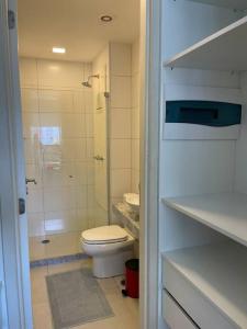 a white bathroom with a toilet and a shower at Flat Premium Recife - Ilha do leite piscina termica in Recife