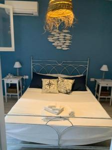 a bedroom with a bed with a blue wall at CASA TRIBOLATI SANTA REPARATA in Santa Reparata