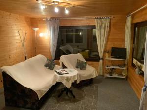 a room with two chairs and a table and a television at Ferienwohnung Silstedt in Wernigerode