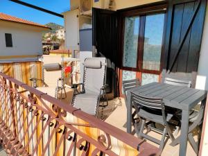 eine Terrasse mit einem Tisch und Stühlen auf dem Balkon in der Unterkunft LIBECCIO "parcheggio privato, terrazzo, grande appartamento uso esclusivo" in Sapri
