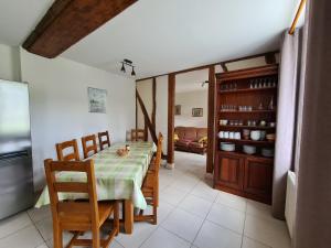 - une cuisine et une salle à manger avec une table et des chaises dans l'établissement Gîte Chailly-en-Gâtinais, 5 pièces, 8 personnes - FR-1-590-7, à Chailly-en-Gâtinais