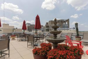a fountain on a patio with tables and chairs at Blueground Bethesda gym nr dining shopping WDC-856 in Bethesda