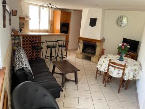 a living room with a couch and a table at Gîte Domptail-en-l'Air, 2 pièces, 2 personnes - FR-1-584-9 