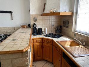 a kitchen with a sink and a counter top at Gîte chaleureux avec terrasse près de Nancy, parking privé, à proximité de festivals et nature - FR-1-584-9 in Domptail-en lʼAir