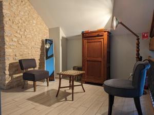 a living room with two chairs and a table at Maison de campagne rénovée à 1h de Paris, avec jardin clos, 4 chambres et équipements familiaux - FR-1-590-164 in Treilles-en-Gâtinais