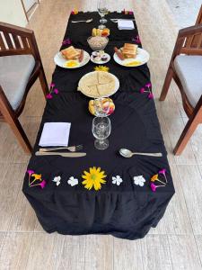 a table with a black table cloth with flowers on it at INFINITE LAGOON in Mandhoo