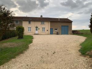 a house with a gravel driveway in front of it at Gîte Forges-sur-Meuse, 4 pièces, 6 personnes - FR-1-585-48 in Forges-sur-Meuse