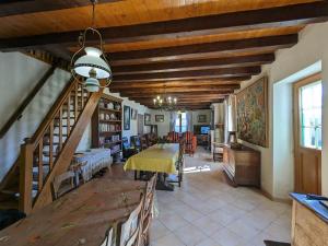 a living room with a table and a staircase at Gîte Saint-Amand-sur-Ornain, 4 pièces, 6 personnes - FR-1-585-56 