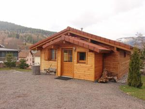 a small wooden cabin with a roof at Chalet romantique avec terrasse, confort moderne, proche activités nature et ski à Cornimont - FR-1-589-41 in Cornimont