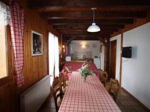 a dining room with a table with a red and white checkered table cloth at Gîte Champdray, 3 pièces, 4 personnes - FR-1-589-64 in Champdray