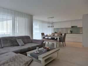 a living room with a couch and a table at Apartment Feldli by Interhome in Meiringen