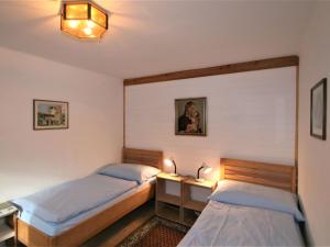 a bedroom with two beds and a desk with lamps at Apartment Hannelore by Interhome in Omes