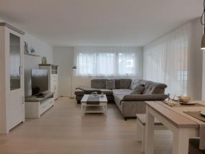 a living room with a couch and a tv at Apartment Feldli by Interhome in Meiringen