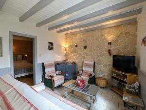 a living room with a couch and chairs and a tv at Charmant chalet de montagne avec terrasse et vue imprenable - FR-1-589-72 in Cornimont