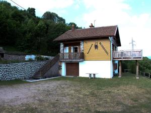 a small house with a deck on top of it at Charmant chalet de montagne avec terrasse et vue imprenable - FR-1-589-72 in Cornimont