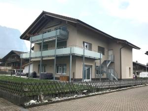 a large house with a balcony on the side of it at Modern little gem close to lake Thun in Reutigen