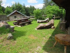 a park with picnic tables and logs in the grass at Gîte Le Tholy, 4 pièces, 6 personnes - FR-1-589-121 in Le Tholy