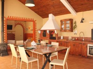 a kitchen with a table and chairs in a room at Holiday Home Quinta Dahlia by Interhome in Pegões