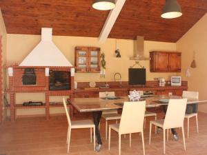 a kitchen with a wooden table and chairs at Holiday Home Quinta Dahlia by Interhome in Pegões +23 photos