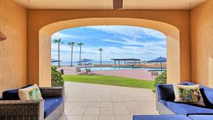 an archway leading to the pool at a resort at Right on the Beach! 1 Bedroom Ground Floor Ocean Front in Puerto Peñasco