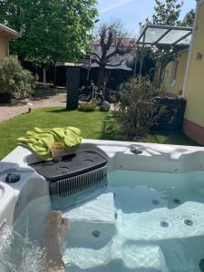 a person is in a jacuzzi in a backyard at Hotel Schützenhof mit Klimaanlage in Bürstadt