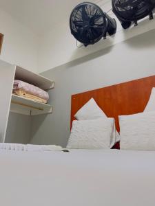 a bedroom with a bed and a fan on the wall at Sunrise Guest Inn in Pretoria