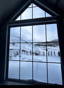 a window with a view of a snow covered field at Shahdag Mountain House in Qusar