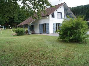 a white house with a playground in the yard at Chalet spacieux avec cheminée, proche forêt, sentiers pédestres, terrasse, terrain clos, jeux et WIFI - FR-1-589-187 in Gerbamont 