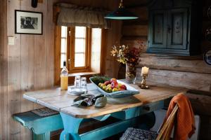 a kitchen with a table with a bowl of fruit on it at Formoseter in Høvringen