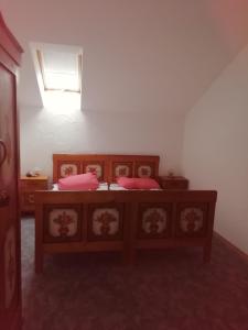 a bedroom with a bed with pink pillows on it at Haus Hiebl in Teisendorf