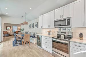 a kitchen with white cabinets and a table and a dining room at New Listing! Pelican Bay 14 -Luxury Home at Beach! in Isle of Palms