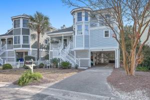 a large blue house with a tree in front of it at New Listing! Pelican Bay 14 -Luxury Home at Beach! in Isle of Palms