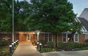 une maison en briques avec un trottoir devant elle dans l'établissement Residence Inn by Marriott Austin Round Rock/Dell Way, à Round Rock