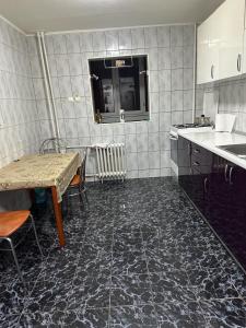 a kitchen with a table and a sink and a table and a tablektop at Dristor Residence in Bucharest