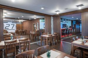 ein Restaurant mit Holztischen und Stühlen in der Unterkunft Vila 27 in Bešeňová + 20 Fotos