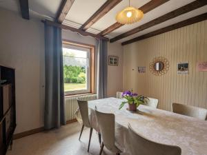 a dining room with a table and a window at Gîte Jussarupt, 4 pièces, 6 personnes - FR-1-589-320 in Jussarupt